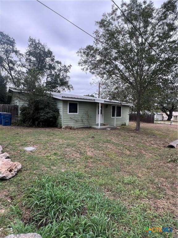 728 W Franklin St, Goliad, TX 77963 - back of house featuring metal roof