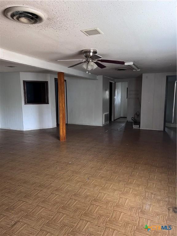 728 W Franklin St, Goliad, TX 77963 - unfurnished living room with ceiling fan and a textured ceiling