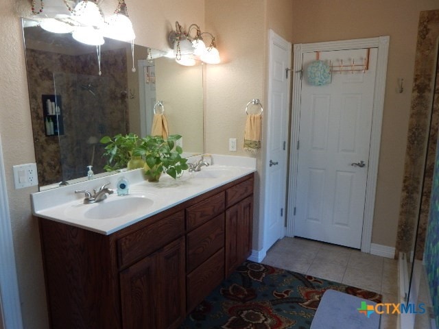 bathroom featuring walk in shower, vanity, and tile patterned floors