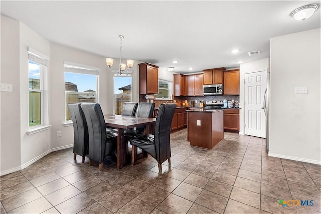 dining room featuring a chandelier, visible vents, baseboards, recessed lighting, and tile patterned flooring