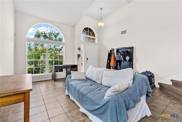 living room featuring light tile patterned flooring, visible vents, and plenty of natural light