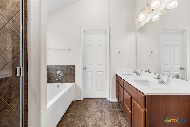 bathroom featuring baseboards, double vanity, a bath, and a sink