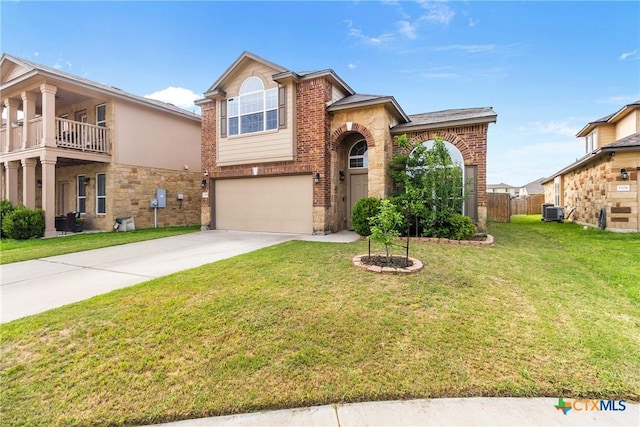 traditional-style home with a front lawn, stone siding, brick siding, concrete driveway, and an attached garage