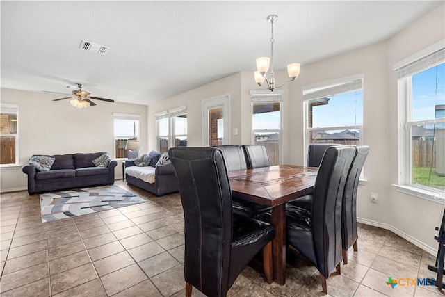 dining space with light tile patterned flooring, visible vents, baseboards, and a healthy amount of sunlight