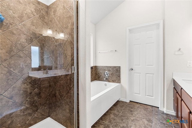bathroom featuring a garden tub, a shower stall, vanity, and baseboards