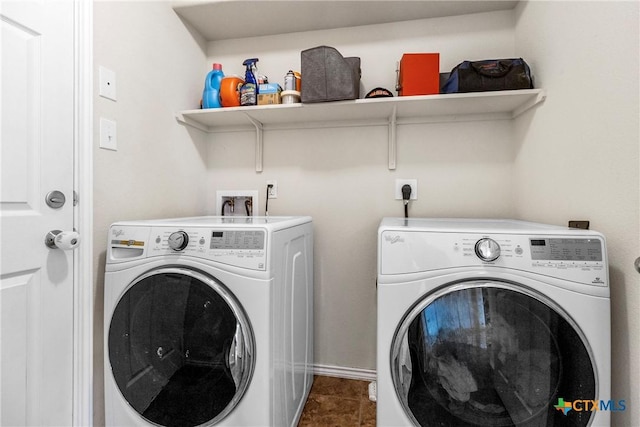 clothes washing area featuring laundry area and washer and clothes dryer
