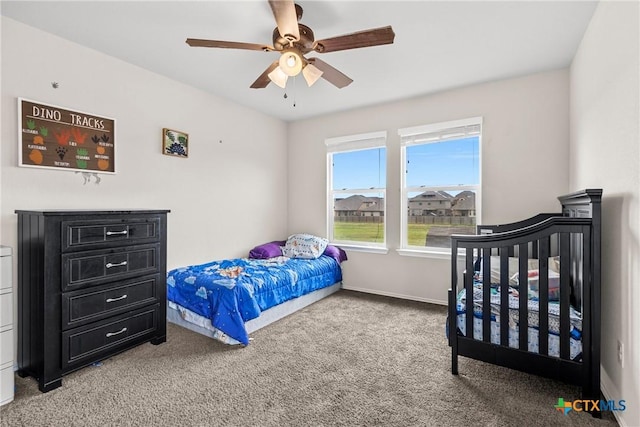 bedroom with light colored carpet, a ceiling fan, and baseboards