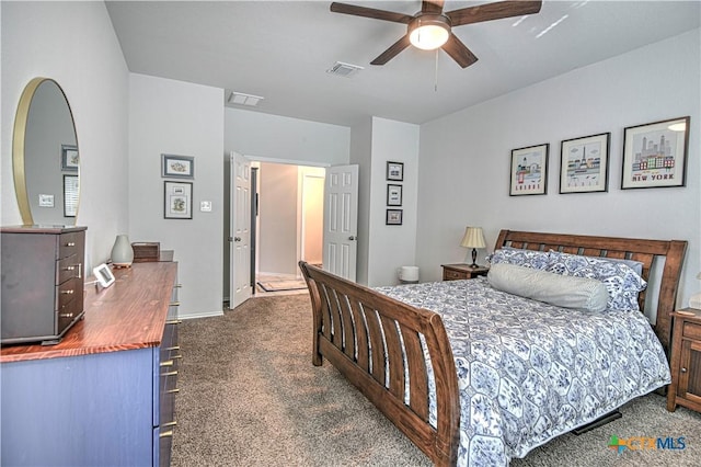 bedroom with visible vents, ceiling fan, and dark carpet