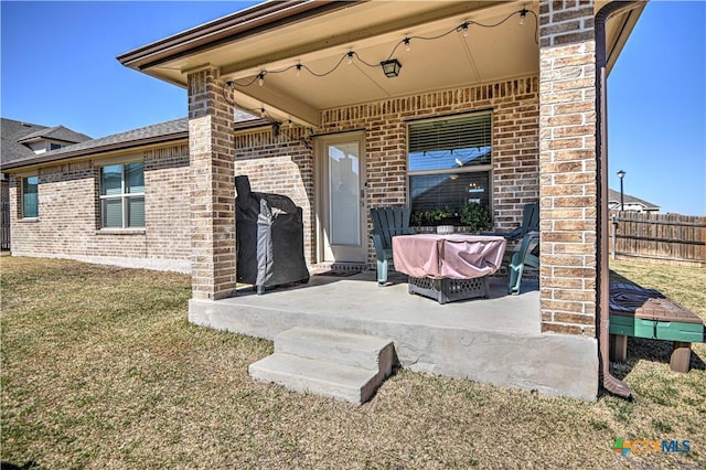 view of patio featuring area for grilling and fence