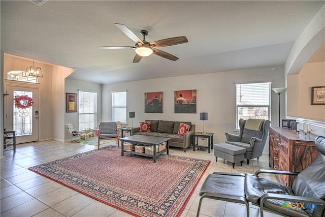 living area with light tile patterned flooring, a healthy amount of sunlight, and ceiling fan