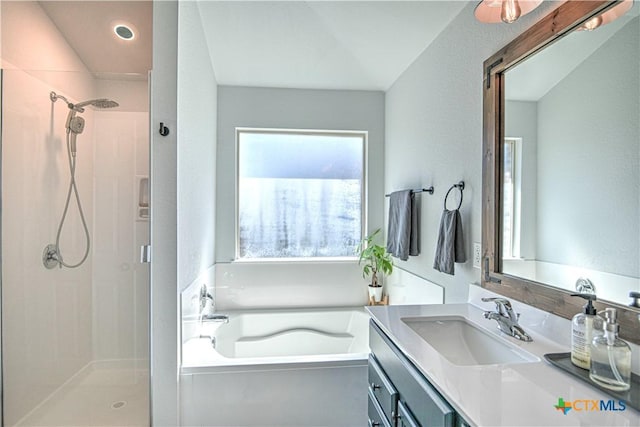 full bath featuring a garden tub, vanity, and a shower stall