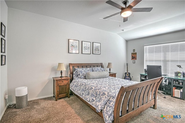 carpeted bedroom with lofted ceiling, a ceiling fan, and baseboards