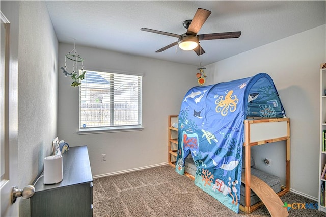 carpeted bedroom featuring baseboards and ceiling fan