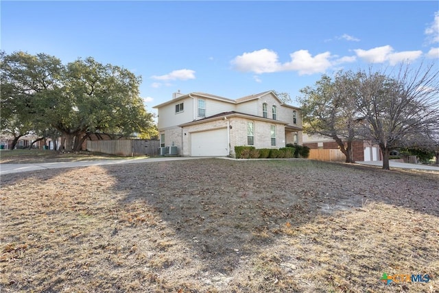 front of property with a garage and central AC unit