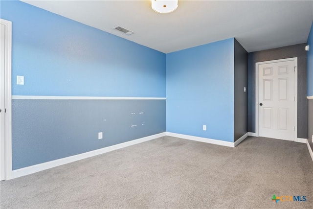 unfurnished room featuring carpet flooring