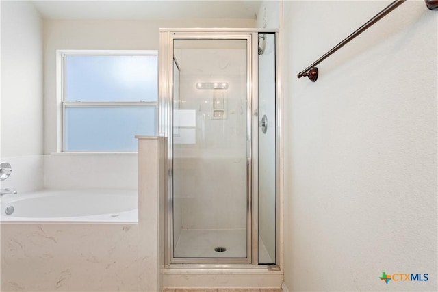 bathroom featuring plus walk in shower