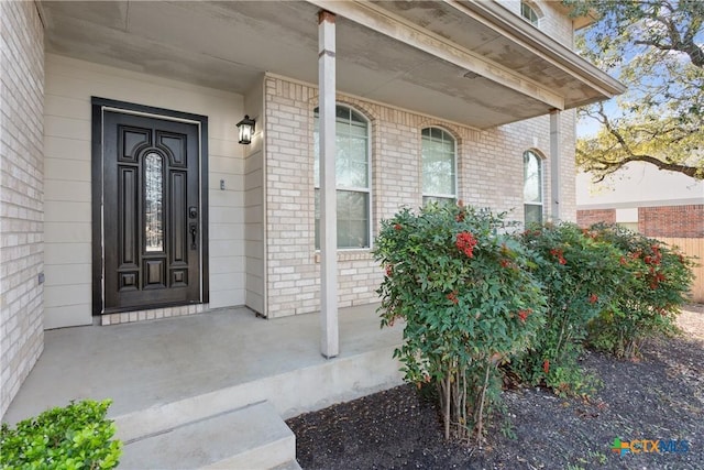 view of exterior entry with covered porch