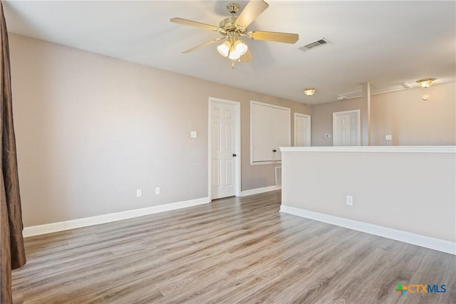 spare room featuring ceiling fan and light hardwood / wood-style flooring