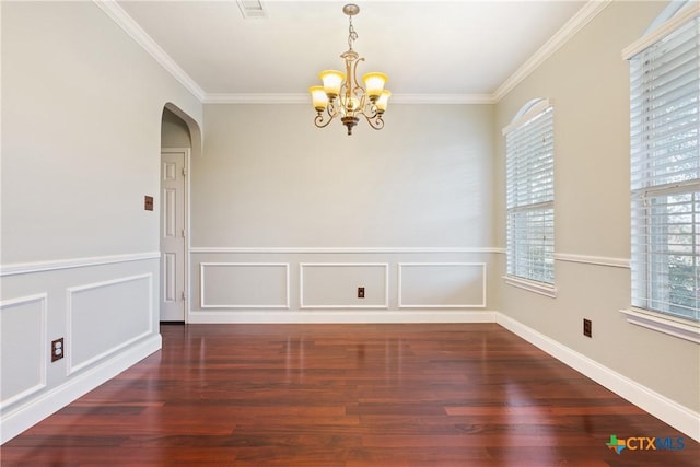 unfurnished room with dark hardwood / wood-style flooring, a chandelier, and ornamental molding