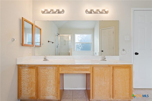 bathroom featuring tile patterned flooring, a shower with door, and vanity