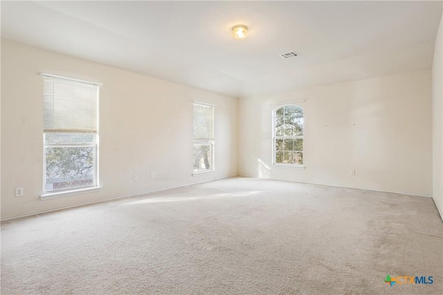 empty room featuring light carpet