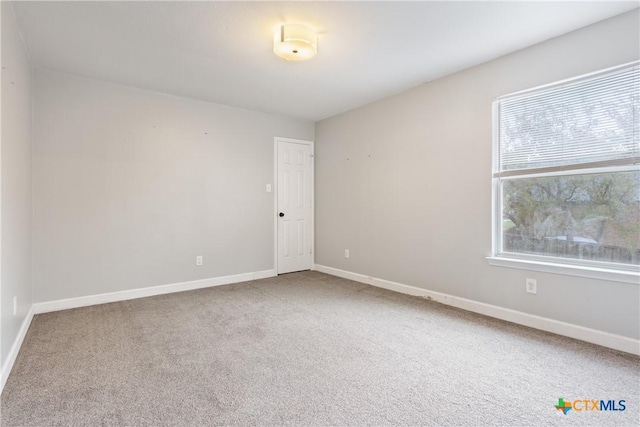 spare room featuring carpet floors and a wealth of natural light