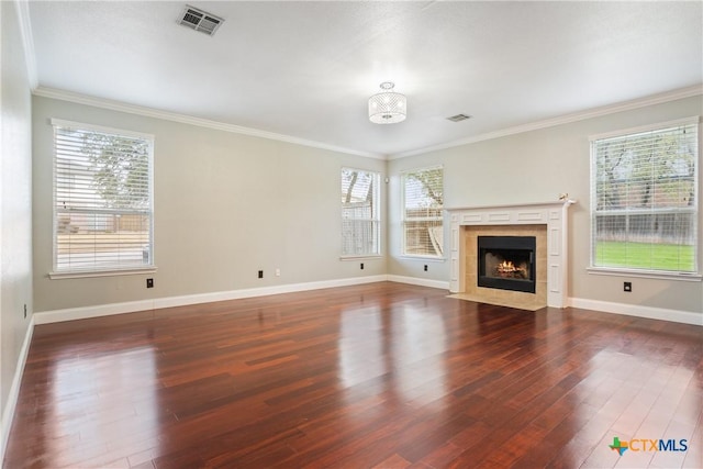 unfurnished living room with dark wood-type flooring, crown molding, and a fireplace