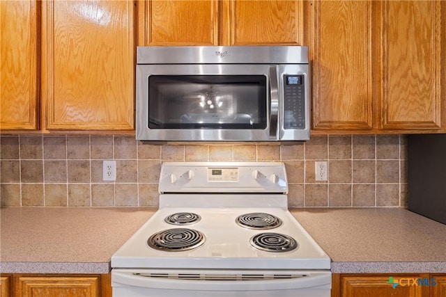 kitchen with electric range and tasteful backsplash