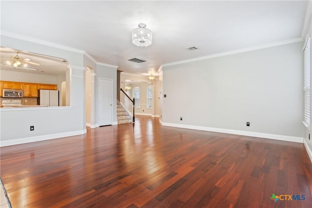 unfurnished living room with ceiling fan with notable chandelier, ornamental molding, and dark hardwood / wood-style floors