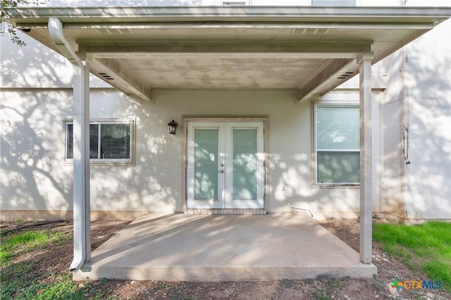 view of exterior entry featuring a patio and french doors