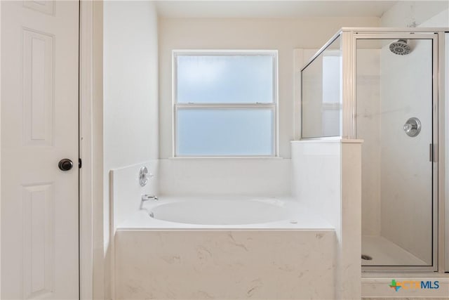 bathroom featuring separate shower and tub and plenty of natural light