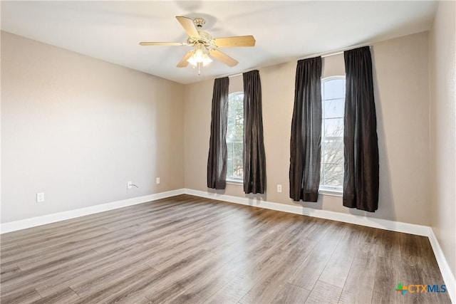 unfurnished room featuring ceiling fan and hardwood / wood-style floors