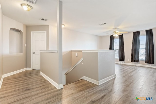 corridor with hardwood / wood-style floors