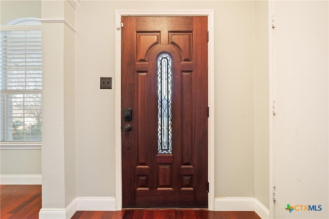 entrance foyer with dark hardwood / wood-style floors