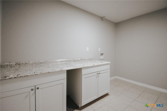 bathroom featuring baseboards and tile patterned flooring