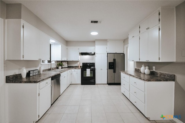 kitchen with visible vents, dark countertops, under cabinet range hood, a sink, and stainless steel appliances
