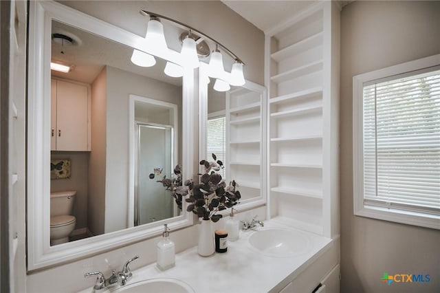 full bath featuring double vanity, a sink, and a shower stall