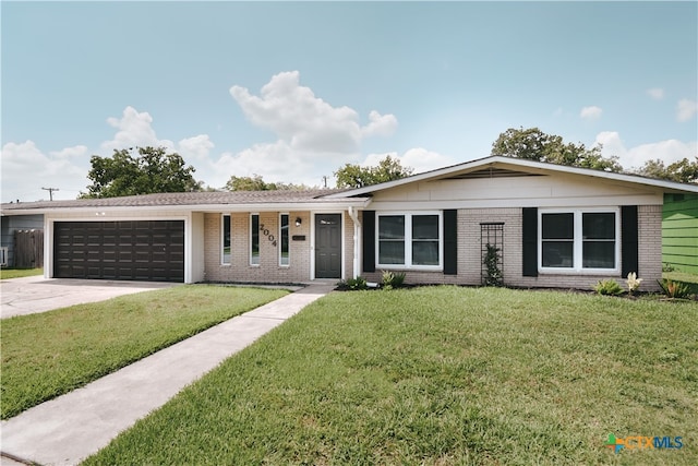 ranch-style house featuring a garage, concrete driveway, brick siding, and a front yard