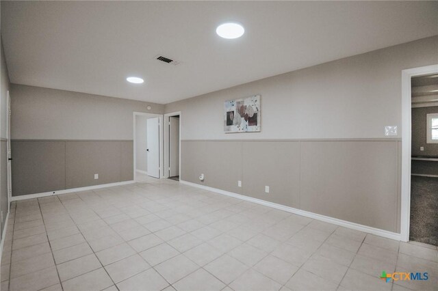 2004 E Loma Vista Ave, Victoria, TX 77901 - spare room with light tile patterned floors, a wainscoted wall, recessed lighting, and visible vents