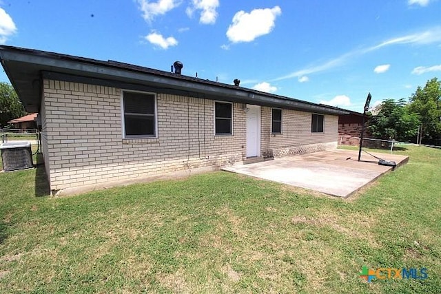 1306 Dryden Ave, Copperas Cove, TX 76522 - back of property featuring a patio, brick siding, and a yard