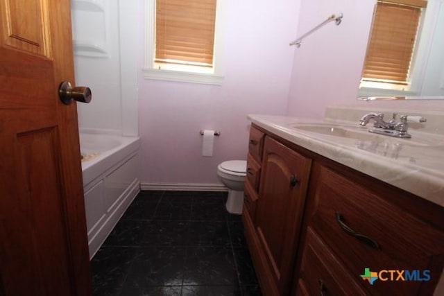 bathroom featuring tile patterned floors, baseboards, toilet, and vanity