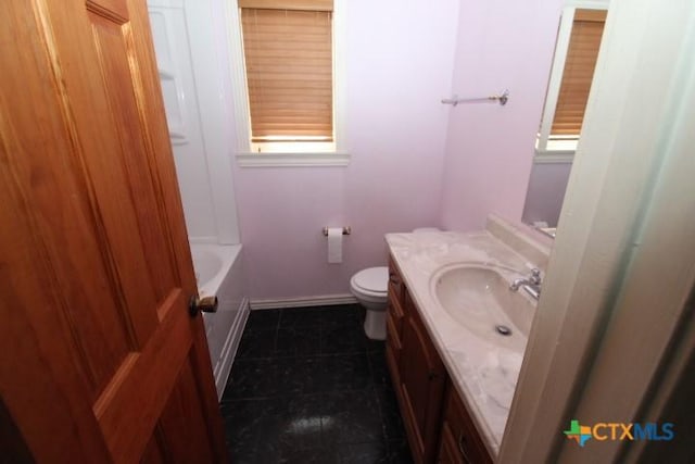 full bathroom with tile patterned floors, toilet, baseboards, a bath, and vanity