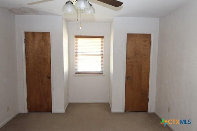 unfurnished bedroom featuring baseboards, a ceiling fan, and carpet flooring