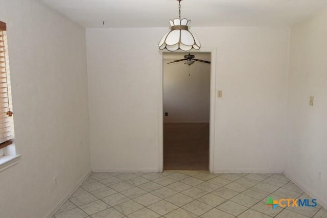 spare room featuring light tile patterned floors and ceiling fan