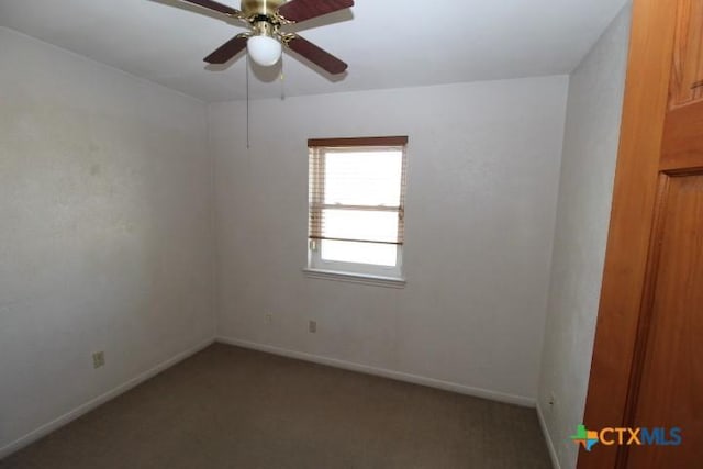 spare room with baseboards, carpet, and ceiling fan