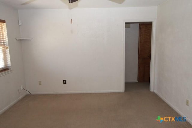 carpeted empty room with baseboards and ceiling fan