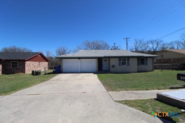 ranch-style home featuring a front lawn, concrete driveway, fence, and a garage