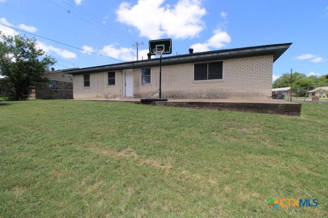 1306 Dryden Ave, Copperas Cove, TX 76522 - rear view of property with brick siding and a lawn