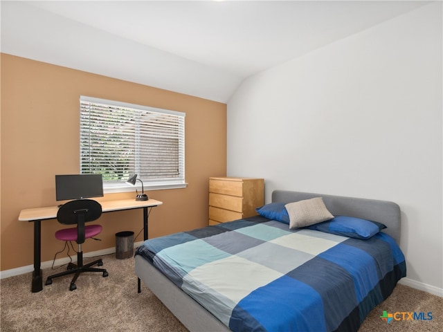 carpeted bedroom with lofted ceiling