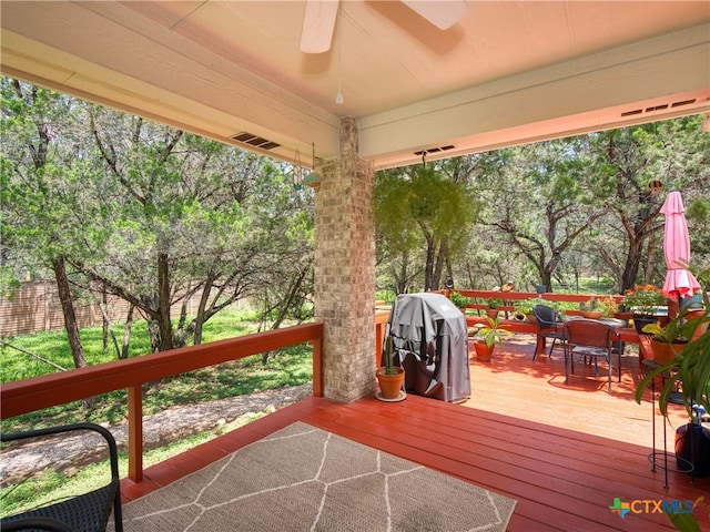 wooden deck featuring ceiling fan and grilling area